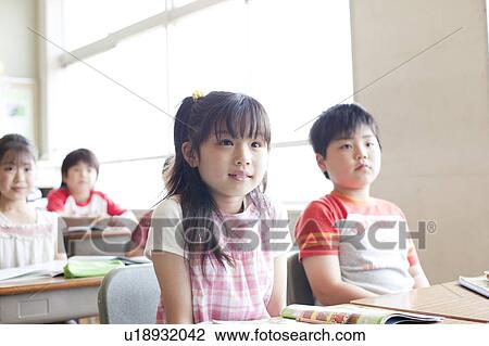 Stock Image - Schoolchildren in Classroom. Fotosearch