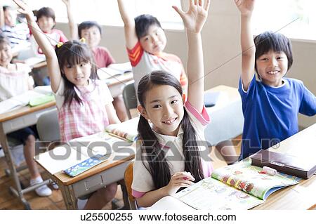Stock Photography - Schoolchildren Raising Hands in Classroom. Fotosearch