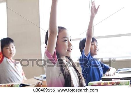 Schoolchildren Raising Hands in Classroom View Large Photo Image Stock Photography - Schoolchildren Raising Hands in Classroom. Fotosearch