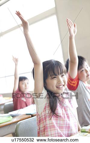 Stock Image - Schoolchildren Raising Hands. Fotosearch