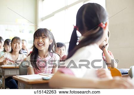Stock Image - Schoolgirl Laughing in Classroom. Fotosearch