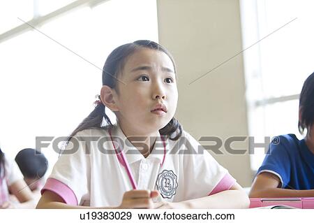 Schoolgirl Listening in Classroom View Large Photo Image Stock Photo - Schoolgirl Listening in Classroom. Fotosearch