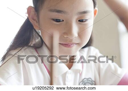 Stock Image - Schoolgirl Smiling and Studying. Fotosearch