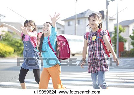 Picture - Schoolgirls crossing street, Japan. Fotosearch
