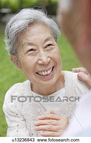 Stock Image - Senior couple standing face to face, Tokyo Prefecture, Honshu, Japan. Fotosearch