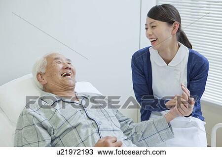 Senior man lying on bed talking to nurse, Kanagawa Prefecture, Honshu, Japan View Large Photo Image Stock Image - Senior man lying on bed talking to nurse, Kanagawa Prefecture, Honshu, Japan. Fotosearch