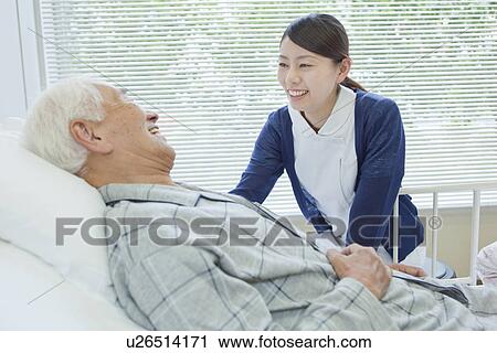 Senior man lying on bed talking to nurse, Kanagawa Prefecture, Honshu, Japan View Large Photo Image Stock Image - Senior man lying on bed talking to nurse, Kanagawa Prefecture, Honshu, Japan. Fotosearch