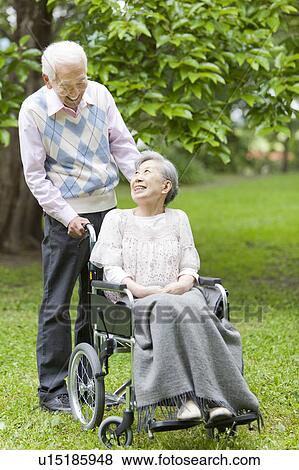 Senior man pushing senior woman on wheelchair, Tokyo Prefecture, Honshu, Japan View Large Photo Image Stock Photo - Senior man pushing senior woman on wheelchair, Tokyo Prefecture, Honshu, Japan. Fotosearch