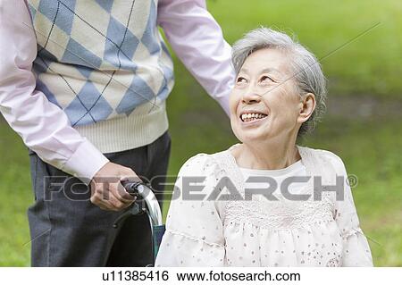 Senior man pushing senior woman on wheelchair, Tokyo Prefecture, Honshu, Japan View Large Photo Image Stock Photograph - Senior man pushing senior woman on wheelchair, Tokyo Prefecture, Honshu, Japan. Fotosearch