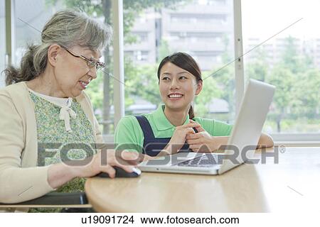 Senior woman and healthcare worker using laptop, Kanagawa Prefecture, Honshu, Japan View Large Photo Image Picture - Senior woman and healthcare worker using laptop, Kanagawa Prefecture, Honshu, Japan. Fotosearch
