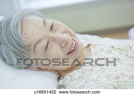Senior woman lying on bed, Kanagawa Prefecture, Honshu, Japan View Large Photo Image Stock Image - Senior woman lying on bed, Kanagawa Prefecture, Honshu, Japan. Fotosearch