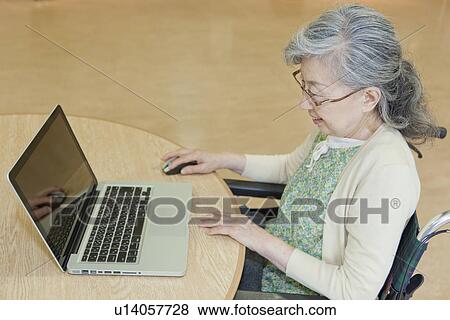 Senior woman using laptop, Kanagawa Prefecture, Honshu, Japan View Large Photo Image Stock Photo - Senior woman using laptop, Kanagawa Prefecture, Honshu, Japan. Fotosearch