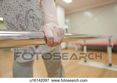 Senior woman using parallel bars, Kanagawa Prefecture, Honshu, Japan View Large Photo Image Stock Photo - Senior woman using parallel bars, Kanagawa Prefecture, Honshu, Japan. Fotosearch