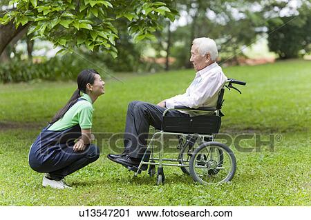 Social Worker with Senior Man on Wheelchair View Large Photo Image Stock Image - Social Worker with Senior Man on Wheelchair. Fotosearch