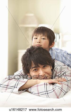 Son Lying on Top of Father View Large Photo Image Stock Photo - Son Lying on Top of Father. Fotosearch