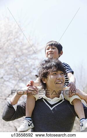 Son on Father's Shoulders View Large Photo Image Stock Image - Son on Father's Shoulders. Fotosearch