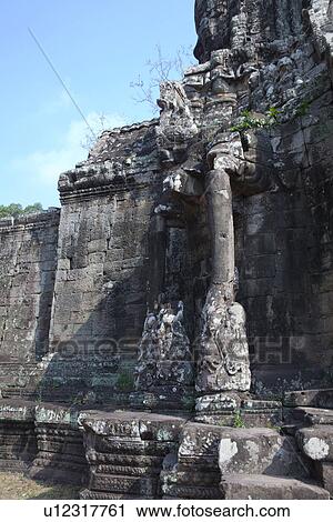 Stock Image - Statue with Elephant Trunk at Angkor Thom. Fotosearch