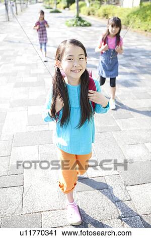 Stock Image - Three Girls Walking to School. Fotosearch