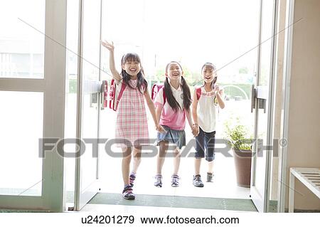 Stock Photo - Three Schoolgirls Arriving at School. Fotosearch