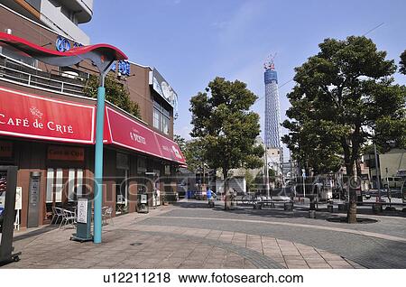 Stock Photo - Town Square with Cafe, Tokyo Sky Tree in Background. Fotosearch