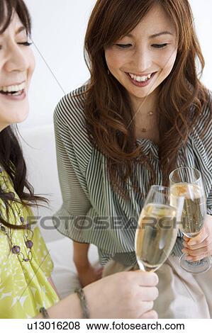 Two Female Friends Toasting with Champagne View Large Photo Image Stock Photo - Two Female Friends Toasting with Champagne. Fotosearch