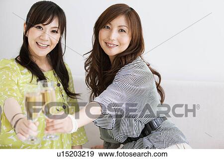 Two Female Friends Toasting with Champagne View Large Photo Image Stock Photo - Two Female Friends Toasting with Champagne. Fotosearch