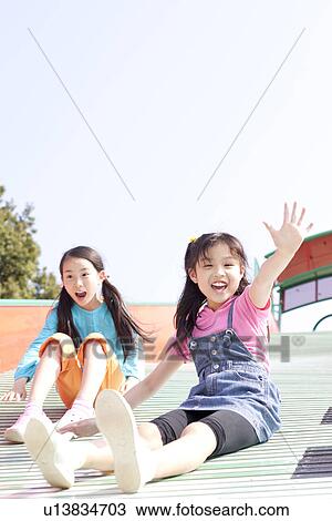 Two Girls on Slide View Large Photo Image Stock Image - Two Girls on Slide. Fotosearch
