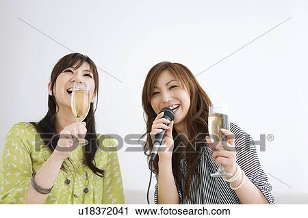 Two Women Singing Karaoke and Having Champagne View Large Photo Image Stock Image - Two Women Singing Karaoke and Having Champagne. Fotosearch
