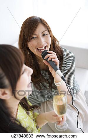 Two Women Singing Karaoke and Having Champagne View Large Photo Image Stock Image - Two Women Singing Karaoke and Having Champagne. Fotosearch