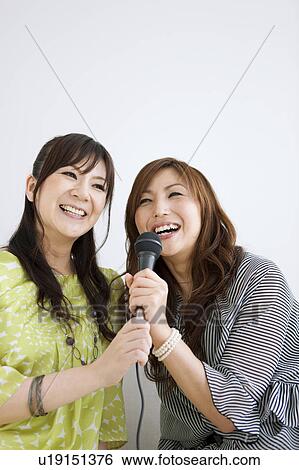 Two Women Singing Karaoke and Having Champagne View Large Photo Image Stock Photograph - Two Women Singing Karaoke and Having Champagne. Fotosearch