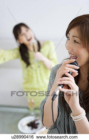 Two Women Singing Karaoke and Having Champagne View Large Photo Image Stock Photograph - Two Women Singing Karaoke and Having Champagne. Fotosearch