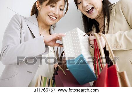 Stock Photo - Two Women With Shopping. Fotosearch