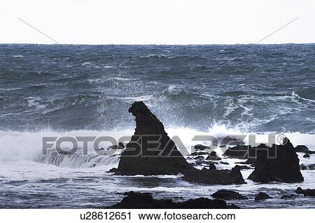 Stock Image - Waves Splashing on Rock. Fotosearch
