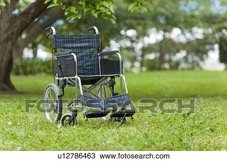 Stock Image - Wheelchair on Grass. Fotosearch