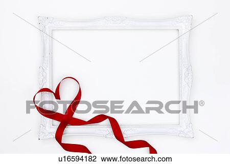 Stock Image - White picture frame and red ribbon. Fotosearch