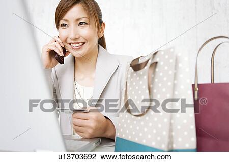 Stock Image - Woman Online shopping. Fotosearch