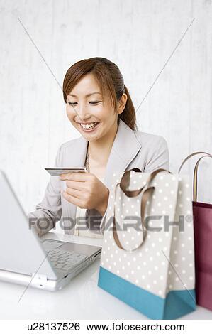 Stock Photograph - Woman Online Shopping. Fotosearch