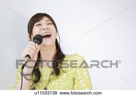 Woman Singing Karaoke View Large Photo Image Stock Photo - Woman Singing Karaoke. Fotosearch