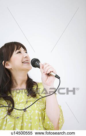Stock Photography - Woman Singing Karaoke. Fotosearch