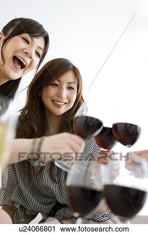 Stock Image - Women Toasting With Red Wine. Fotosearch