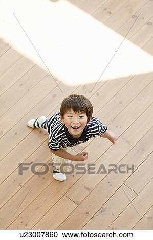Young Boy on Wooden Floor View Large Photo Image Stock Image - Young Boy on Wooden Floor. Fotosearch