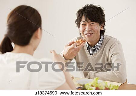 Stock Image - Young Couple Eating Pizza. Fotosearch