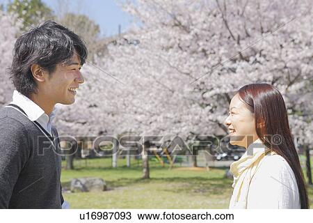 Stock Image - Young Couple in Park. Fotosearch