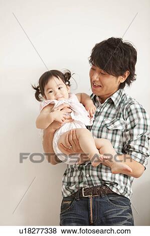 Stock Photo - Young Father with Baby Girl. Fotosearch