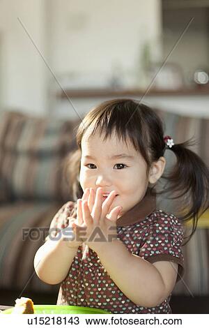 Stock Image - Young Girl with Hands Clasped. Fotosearch