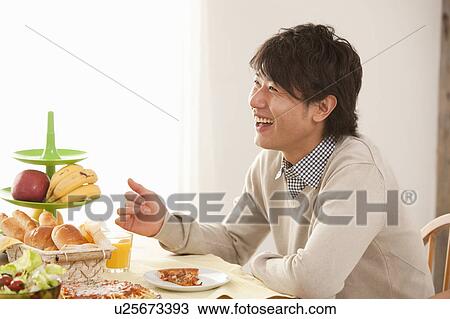 Stock Image - Young Man Having Lunch. Fotosearch