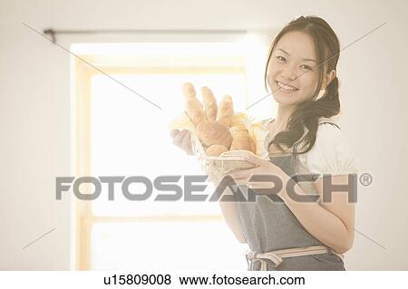 Young Woman Holding Bread Basket View Large Photo Image Stock Photo - Young Woman Holding Bread Basket. Fotosearch