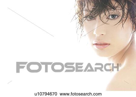 Stock Image - Young woman looking at camera. Fotosearch