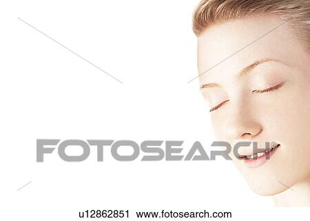 Stock Image - Young woman with eyes closed. Fotosearch