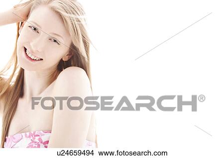 Young woman with hand in hair View Large Photo Image Picture - Young woman with hand in hair. Fotosearch